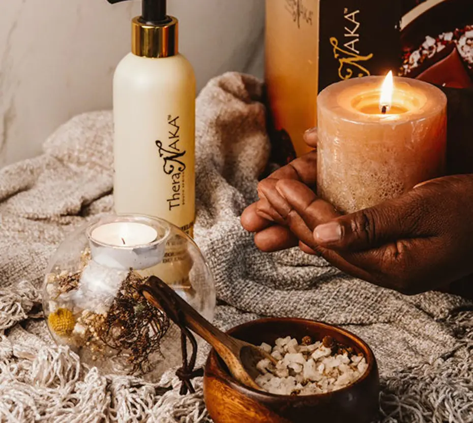 TheraNaka skincare products on a wooden table at Pause Spa