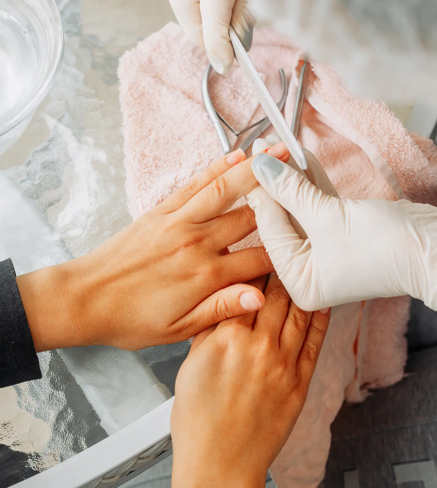 Therapist performing an Express Manicure treatment on a client's hands at Pause Spa