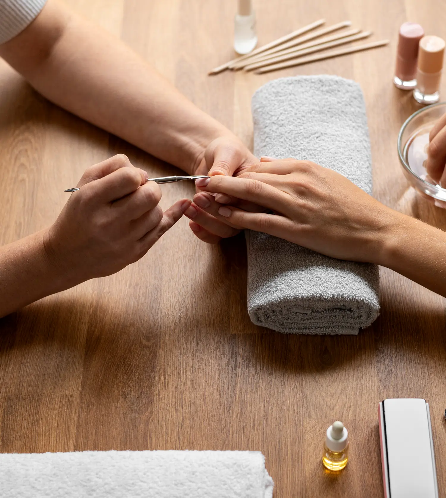 Therapist performing a File & Paint Nails Only treatment on a client's hands at Pause Spa