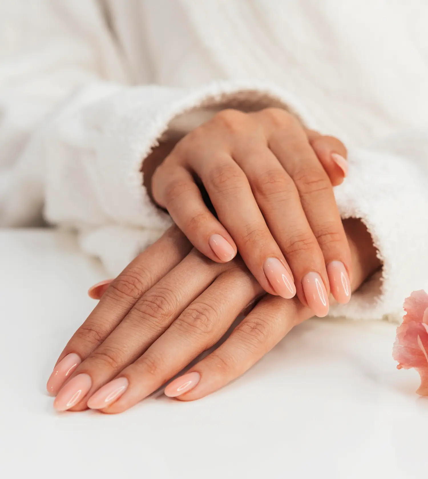 Woman's hands after receiving a gel overlay treatment at Pause Spa