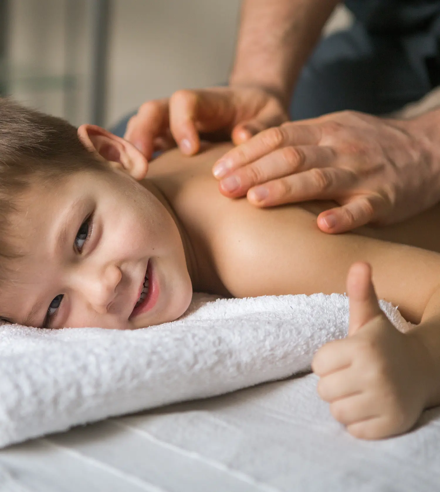 A young boy receiving a back massage during his Kiddies Pamper Package experience at Pause Spa