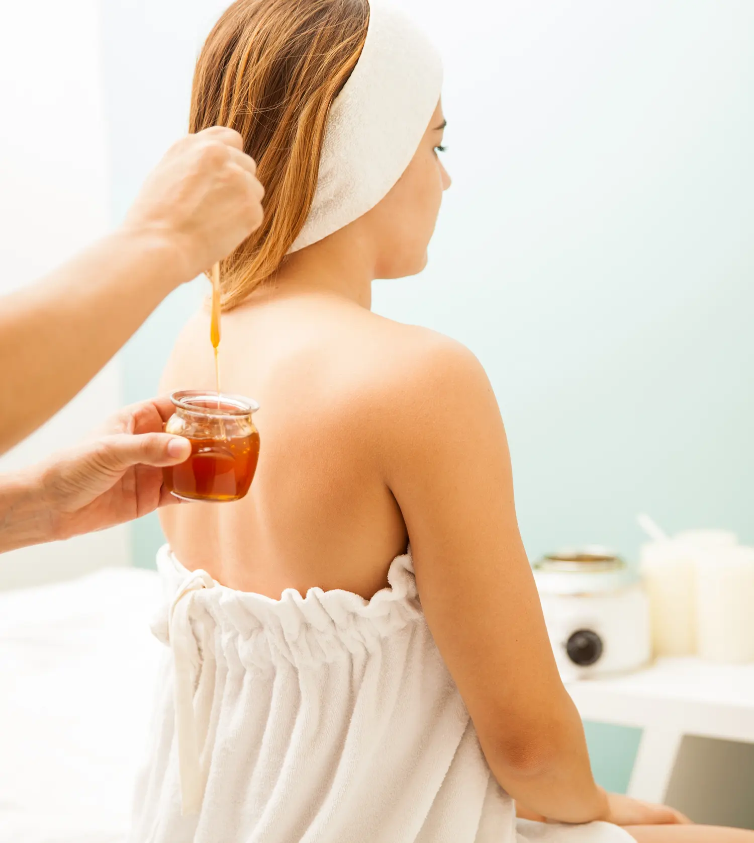 Woman waiting for the therapist to apply wax to her back during her Full Back Wax experience at Pause Spa